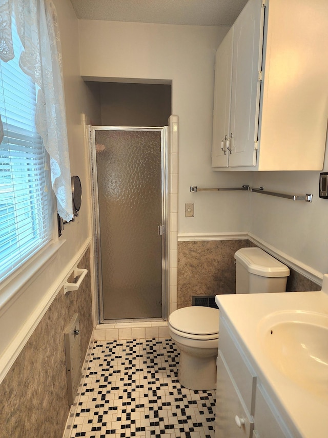 2023 Pisgah Rd, North Augusta, SC 29841 - bathroom with wainscoting, vanity, a shower stall, tile walls, and tile patterned floors
