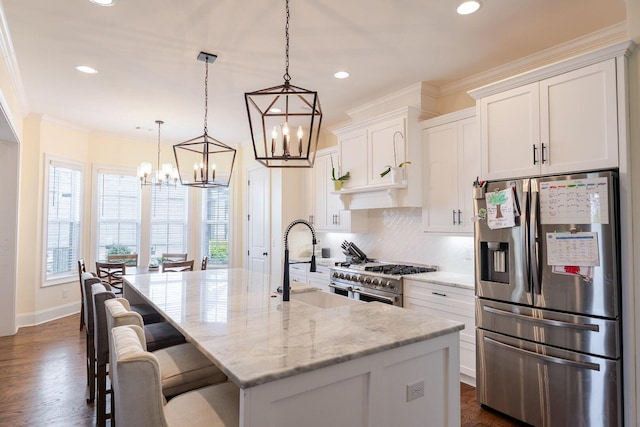 719 Nuttall St, Evans, GA 30809 - kitchen with stainless steel appliances, a chandelier, healthy amount of natural light, white cabinets, and recessed lighting
