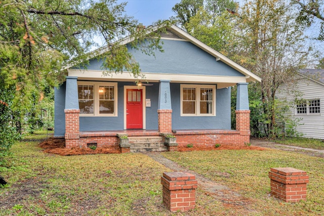 view of front of house with a porch and a front lawn