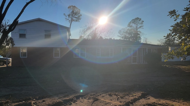 view of back house at dusk