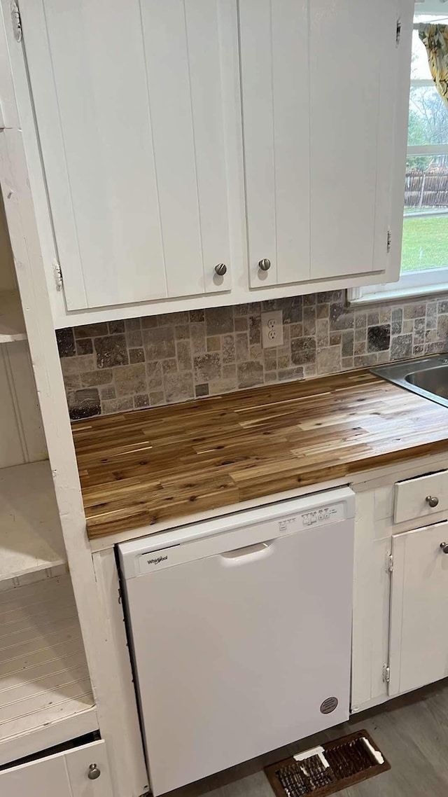 kitchen featuring backsplash, white cabinetry, and dishwasher