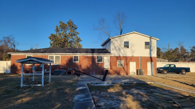 back of house with central AC unit