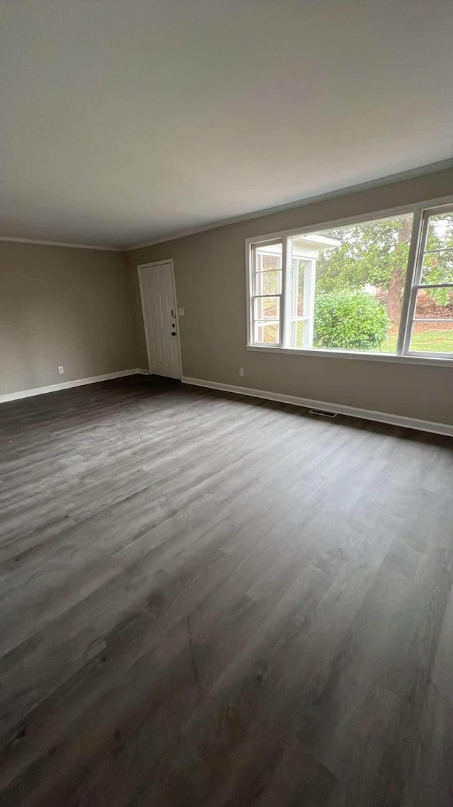 unfurnished room featuring dark hardwood / wood-style floors