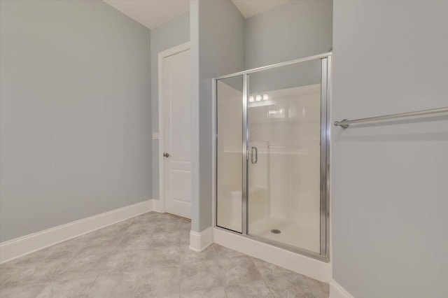 bathroom featuring a shower with shower door