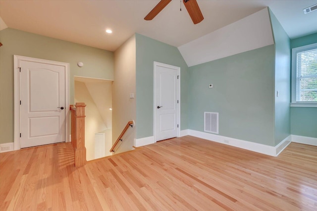 bonus room with light wood-type flooring, vaulted ceiling, and ceiling fan