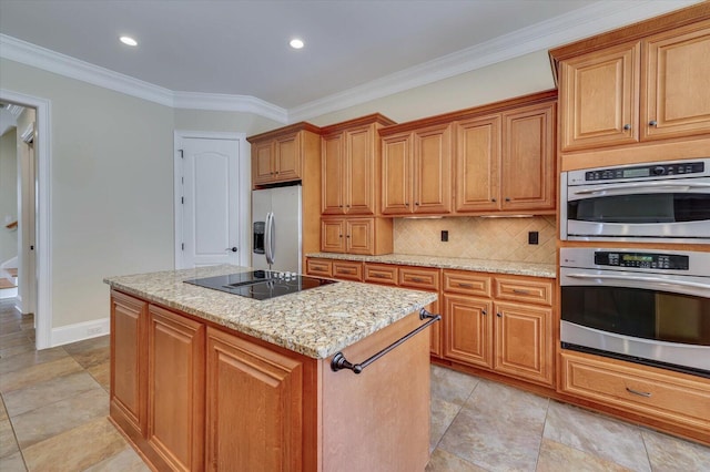 kitchen featuring crown molding, decorative backsplash, appliances with stainless steel finishes, a kitchen island, and light stone counters