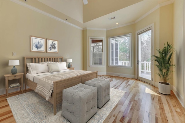 bedroom with access to exterior, ornamental molding, and light hardwood / wood-style flooring