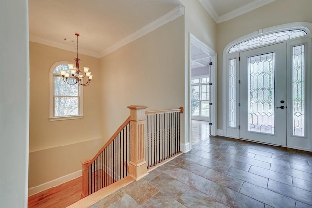 entrance foyer featuring a chandelier and ornamental molding