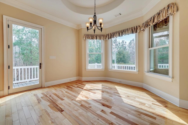 unfurnished dining area with a chandelier, light hardwood / wood-style flooring, and ornamental molding