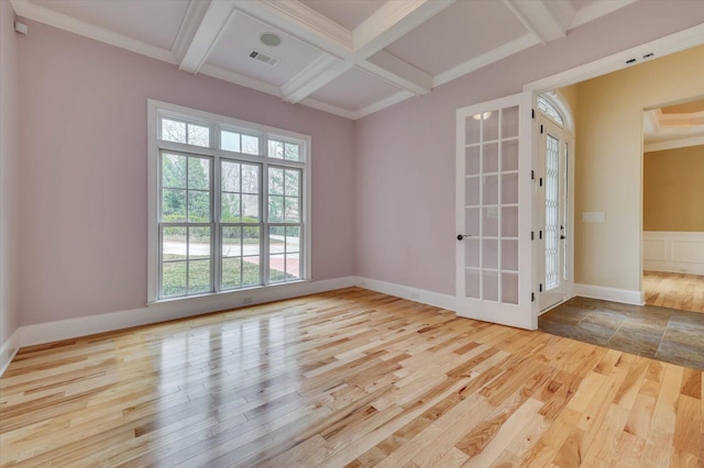 spare room featuring french doors, beamed ceiling, light hardwood / wood-style floors, and coffered ceiling