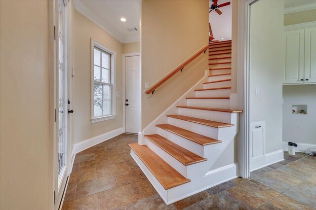 entrance foyer with ceiling fan and ornamental molding