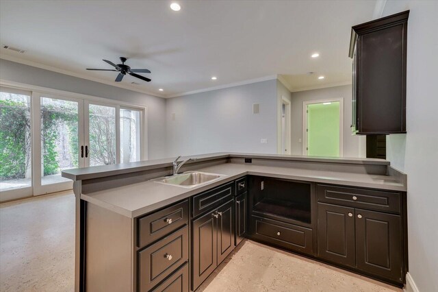 kitchen with ceiling fan, sink, french doors, kitchen peninsula, and ornamental molding