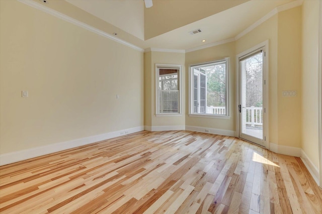 unfurnished room featuring crown molding and light hardwood / wood-style flooring