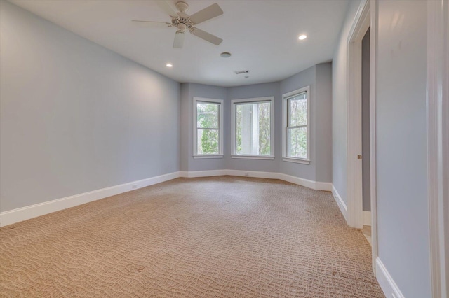 unfurnished room featuring ceiling fan and light carpet