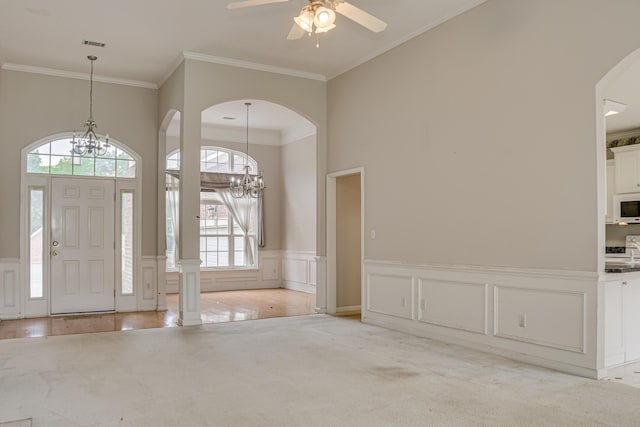 215 Mineral Ct, Evans, GA 30809 - entryway with a chandelier, arched walkways, plenty of natural light, crown molding, and a decorative wall