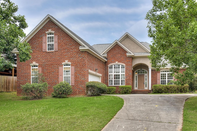 215 Mineral Ct, Evans, GA 30809 - traditional home featuring brick siding, an attached garage, concrete driveway, and stucco siding