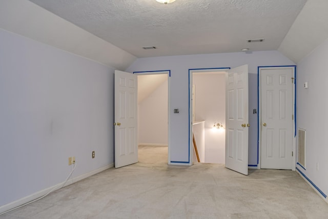 215 Mineral Ct, Evans, GA 30809 - unfurnished bedroom with vaulted ceiling, light colored carpet, and a textured ceiling