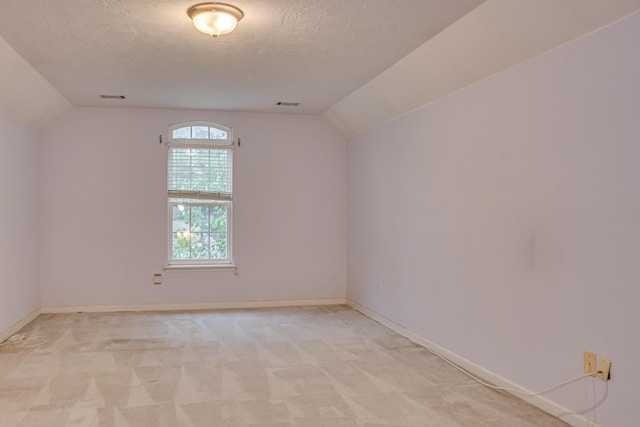 215 Mineral Ct, Evans, GA 30809 - empty room with vaulted ceiling, a textured ceiling, and light carpet