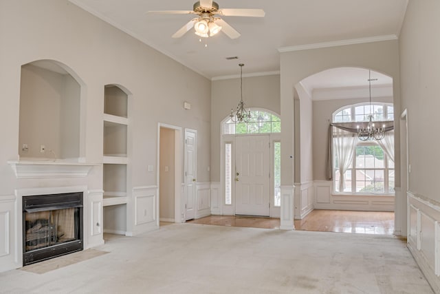 215 Mineral Ct, Evans, GA 30809 - foyer featuring carpet, a decorative wall, ornamental molding, a fireplace with flush hearth, and a chandelier