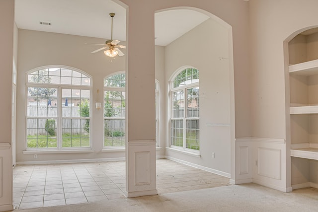 215 Mineral Ct, Evans, GA 30809 - spare room featuring a ceiling fan, tile patterned floors, arched walkways, and carpet floors