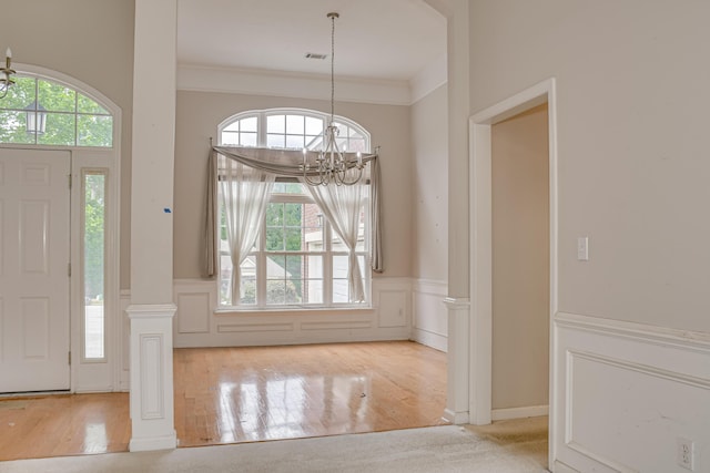 215 Mineral Ct, Evans, GA 30809 - entryway with a chandelier, plenty of natural light, wainscoting, a decorative wall, and crown molding