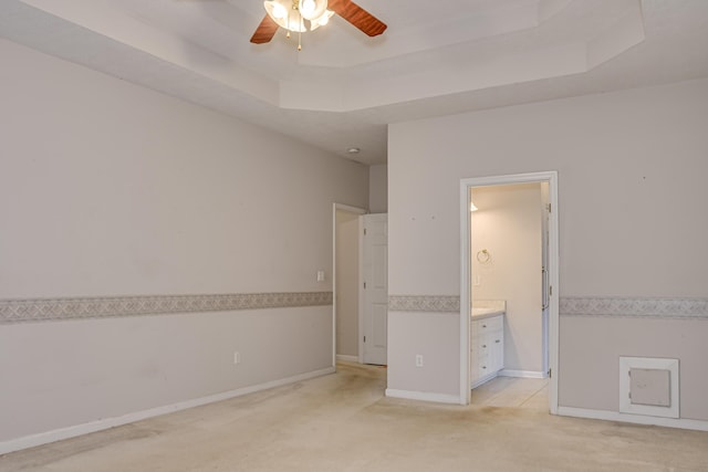 215 Mineral Ct, Evans, GA 30809 - unfurnished bedroom featuring light colored carpet, a raised ceiling, and connected bathroom