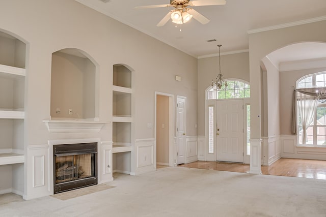 215 Mineral Ct, Evans, GA 30809 - carpeted entryway featuring healthy amount of natural light, crown molding, ceiling fan, a fireplace with flush hearth, and a wainscoted wall
