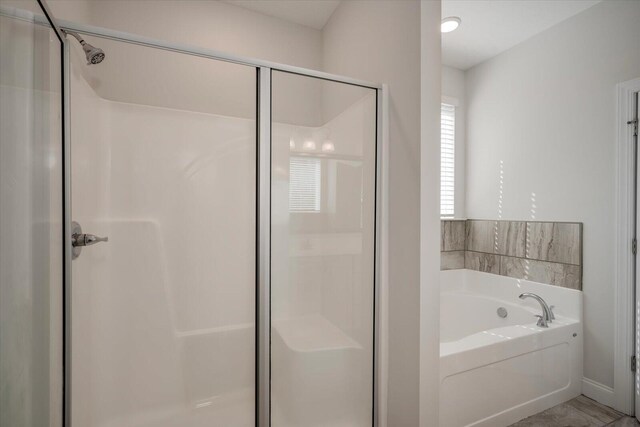 bathroom featuring independent shower and bath