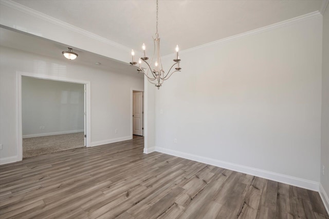 unfurnished dining area featuring hardwood / wood-style floors, ornamental molding, and a chandelier