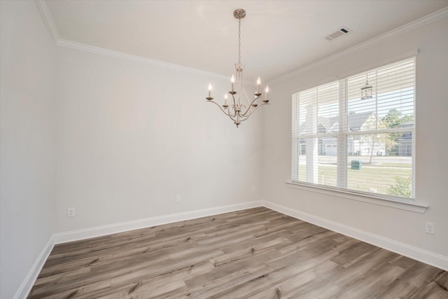 unfurnished room with a chandelier, hardwood / wood-style floors, and ornamental molding