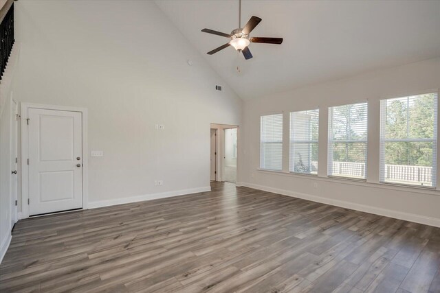 unfurnished living room featuring ceiling fan, high vaulted ceiling, and hardwood / wood-style flooring