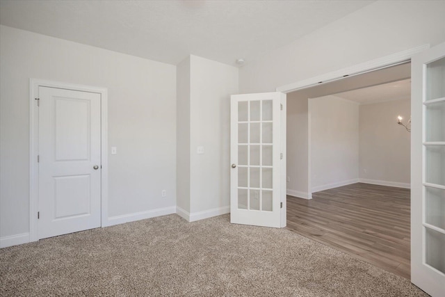 spare room with carpet and french doors