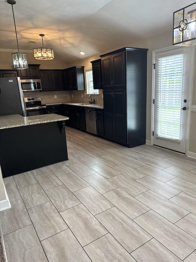 5186 Copse Dr, Augusta, GA 30909 - kitchen with appliances with stainless steel finishes, light stone counters, decorative light fixtures, backsplash, and dark cabinets