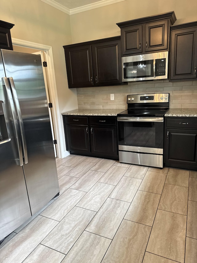 5186 Copse Dr, Augusta, GA 30909 - kitchen featuring stainless steel appliances, crown molding, backsplash, and light stone countertops