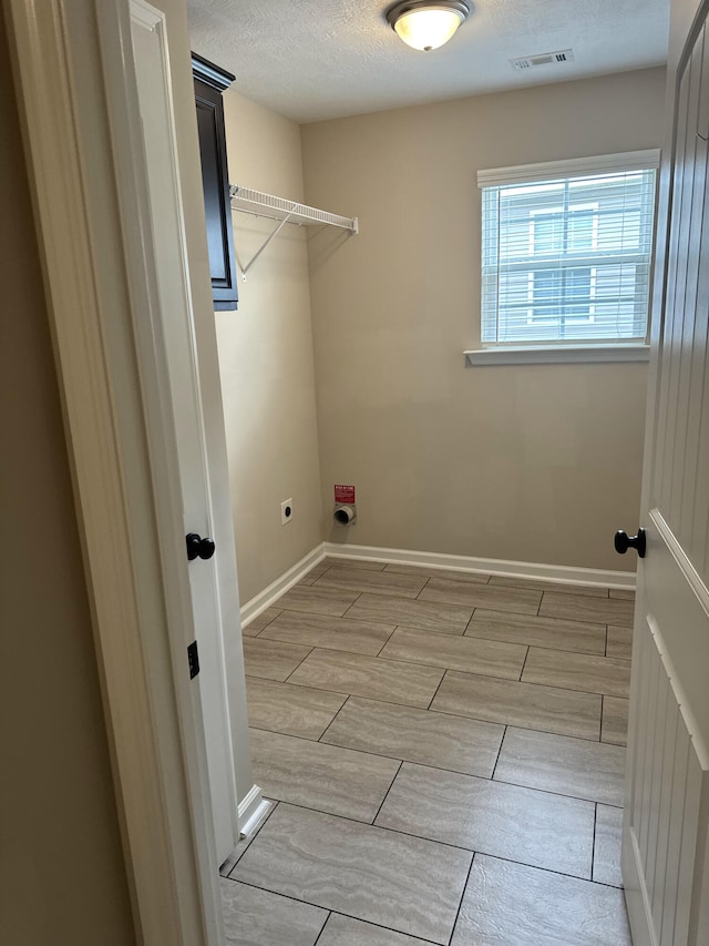 5186 Copse Dr, Augusta, GA 30909 - laundry area with hookup for an electric dryer, wood tiled floors, and a textured ceiling
