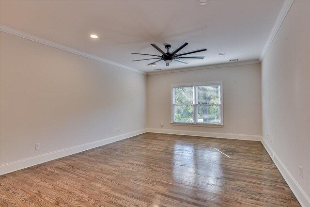 empty room featuring crown molding, ceiling fan, and wood-type flooring