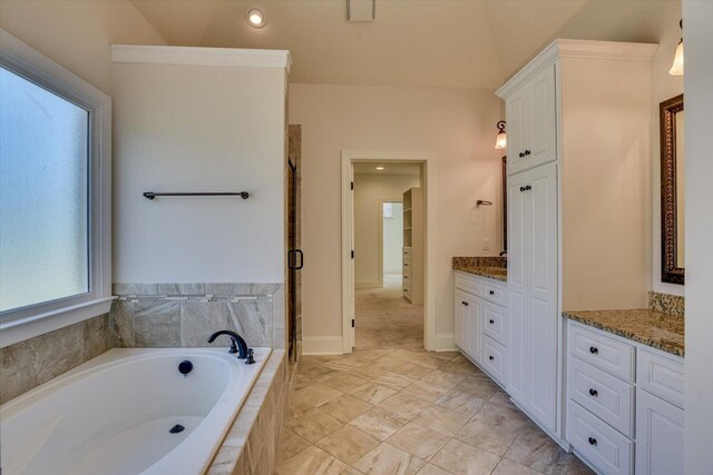 bathroom featuring shower with separate bathtub and vanity