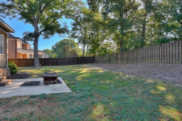 view of yard featuring a patio and a fire pit