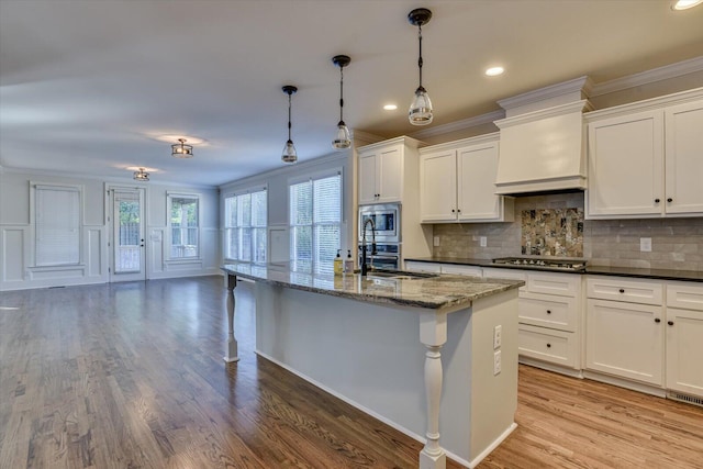 kitchen featuring crown molding, sink, premium range hood, and appliances with stainless steel finishes