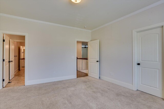 unfurnished bedroom with light colored carpet and ornamental molding