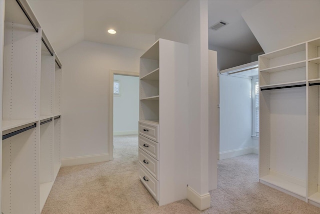 spacious closet featuring light carpet and lofted ceiling