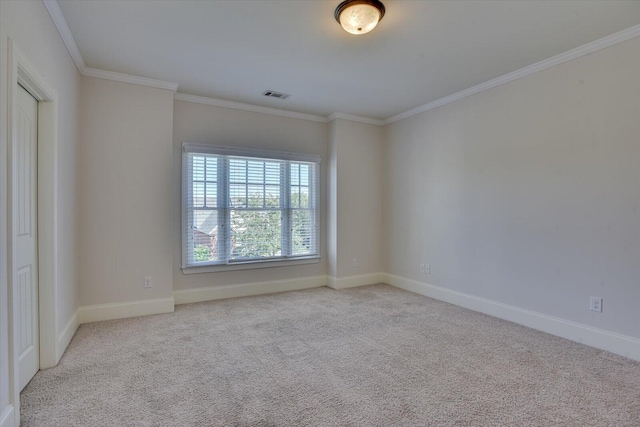 carpeted spare room featuring ornamental molding