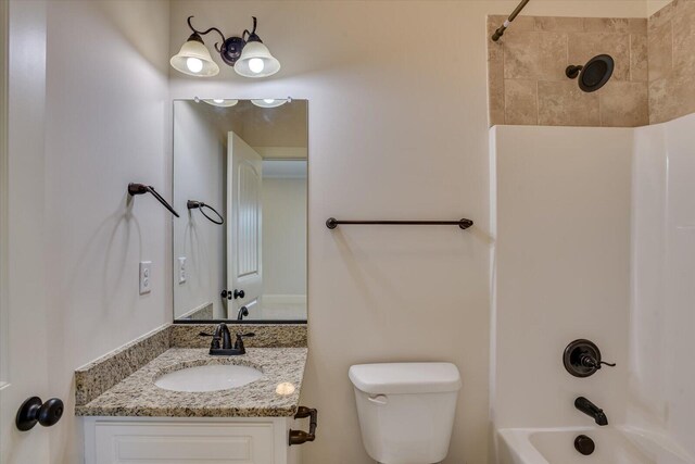 full bathroom featuring vanity, tiled shower / bath combo, and toilet