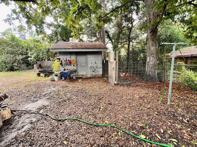 view of yard featuring an outdoor structure and fence