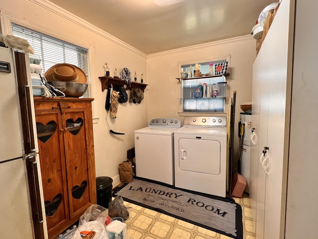 clothes washing area featuring baseboards, ornamental molding, water heater, laundry area, and separate washer and dryer