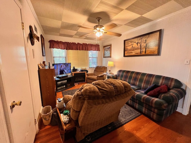 living area featuring ornamental molding, ceiling fan, and wood finished floors