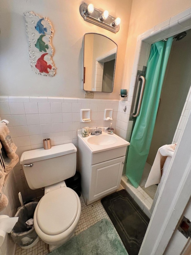 full bathroom with vanity, tile patterned flooring, a shower stall, tile walls, and toilet