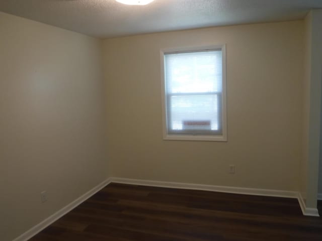 402 Parliment Rd, Martinez, GA 30907 - spare room with dark wood-type flooring and baseboards