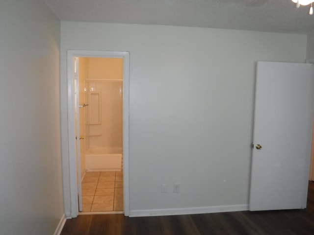 402 Parliment Rd, Martinez, GA 30907 - unfurnished bedroom featuring ensuite bath and dark wood-type flooring