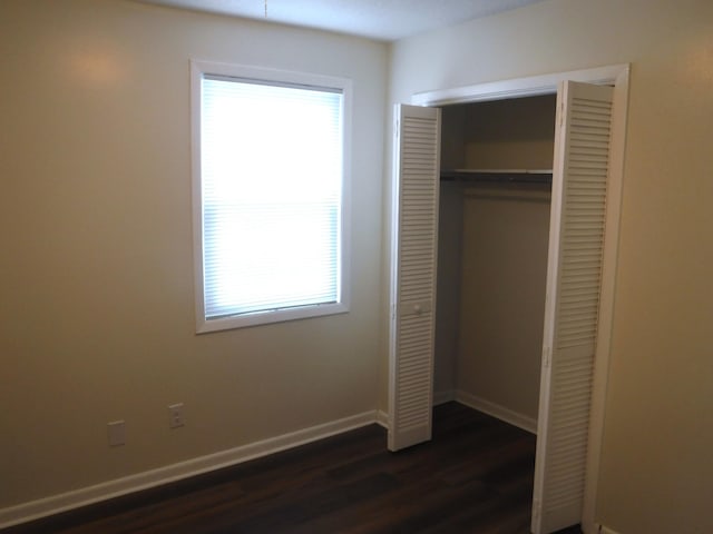 402 Parliment Rd, Martinez, GA 30907 - unfurnished bedroom with dark wood finished floors and a closet